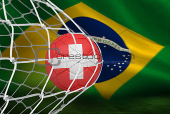 Football in swiss colours at back of net
