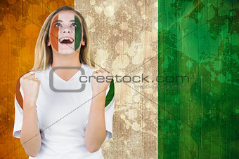 Excited ivory coast fan in face paint cheering