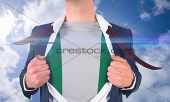 Businessman opening shirt to reveal nigeria flag