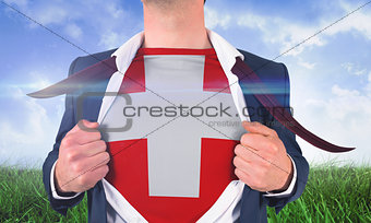 Businessman opening shirt to reveal swiss flag
