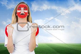 Excited fan in swiss face paint cheering