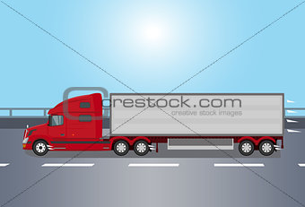 Red american truck on the road early morning
