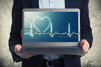 laptop with ekg on the screen 