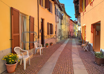 Narrow cobbled street among colorful houses in Italy.
