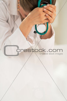 Closeup on stressed medical doctor woman in office