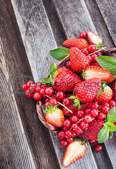 Fresh strawberry and redcurrant in a basket