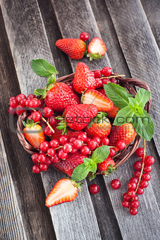 Fresh strawberry and redcurrant in a basket 
