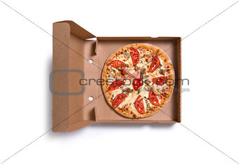 Delicious Italian pizza with ham and tomatoes in box 