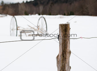Wagon in Fenced Snowy Field