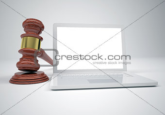 Gavel and open white laptop