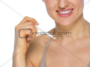 Closeup on happy young woman holding white pencil