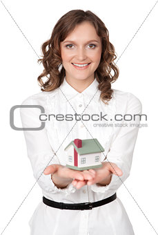 Beautiful young woman holding house model