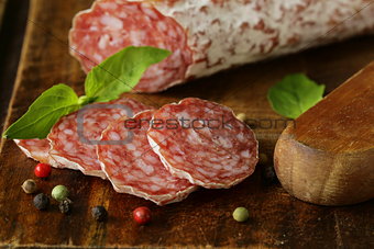 delicacy smoked sausage (salami) on a wooden board