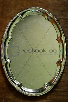 metallic silver tray on a wooden background