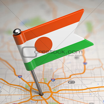 Niger Small Flag on a Map Background.