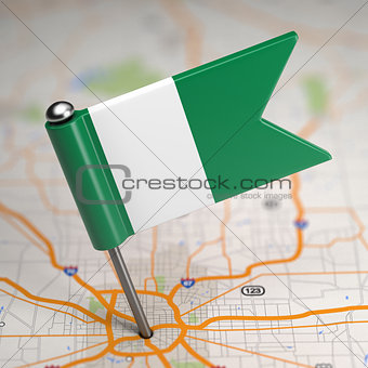 Nigeria Small Flag on a Map Background.