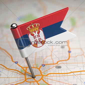 Serbia Small Flag on a Map Background.