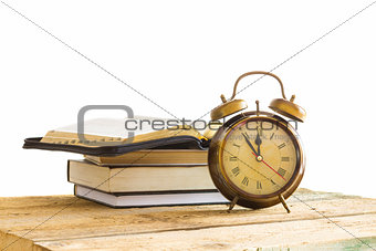 Bible with clock on wood