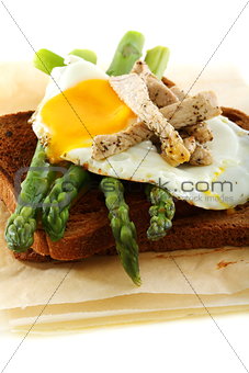 Asparagus, egg and turkey on rye bread.