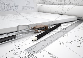 Scrolls engineering drawings and laptop