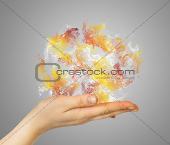 Hand holding colored smoke
