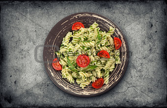 Fusilli pasta with tomato and arugula