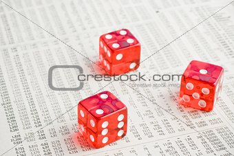 red dice on the financial newspaper