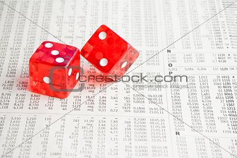 two red dice on the financial newspaper