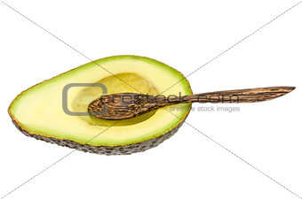 Fresh avocado with wooden spoon isolated