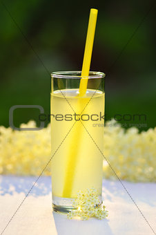 Glass of natural elderflower juice with lemon.