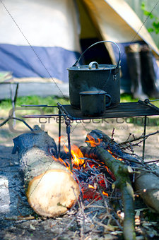 Tourist boiler mug and heated over a fire of wood