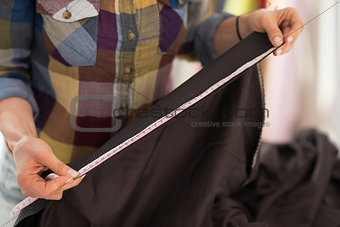 Closeup on seamstress measuring fabric