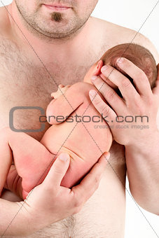 hands of a father holding his newborn baby girl 