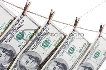 Hundred Dollar Bills Hanging From Clothesline on White