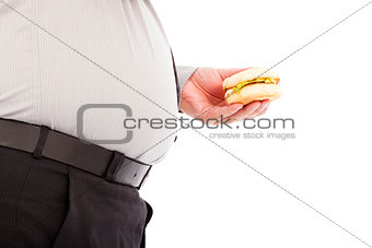 fat business man holding a hamburger fastfood