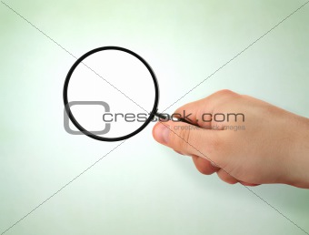 male hand holding magnifying glass