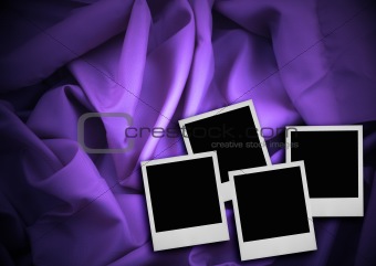 four photo frames against textile background