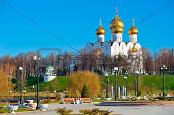 White-stone cathedral with golden domes on the hill