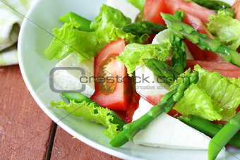fresh salad with tomatoes, asparagus and cheese