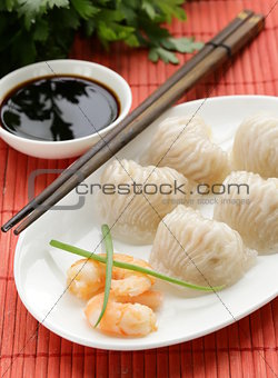 Asian steamed meat dumplings dim sum with soy sauce