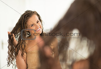 Portrait of happy young woman with wet hair in bathroom