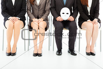 business people waiting for job interview with a strange mask 
