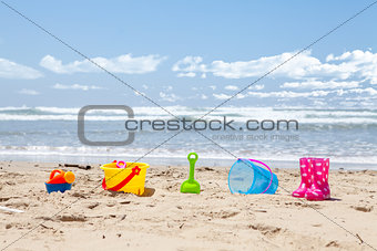Brightly colored plastic beach toys on the beach