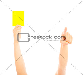 Hand of referee with yellow card to warn