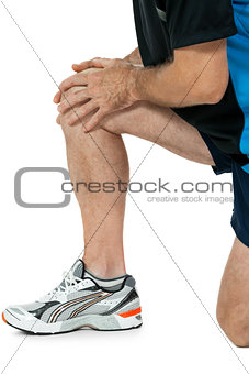 adult attractive man in sportswear knee pain injury ache isolated