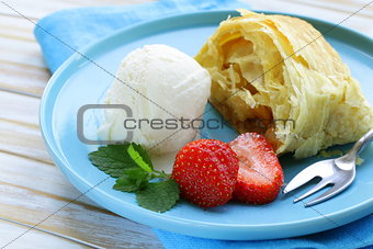 traditional apple strudel with raisins, served with a scoop of ice cream