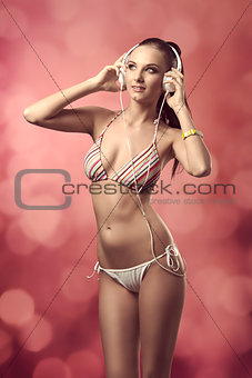 woman in bikini listening music 
