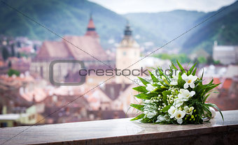 Wedding bouquet spring flowers with Brasov city view panoramic 