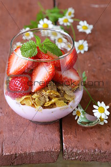 Dairy yogurt dessert with muesli and strawberries