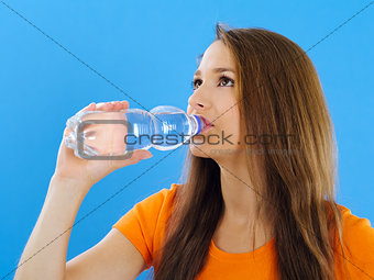 Young woman drinking bottled water